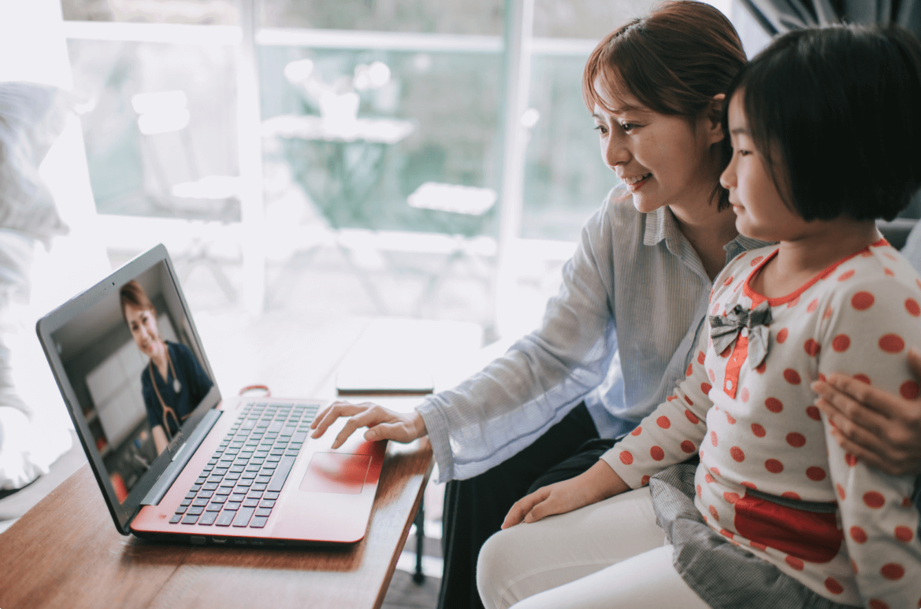 Woman and child meeting with telehealth provider via laptop