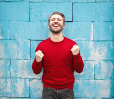 healthy man in red sweater happy about having online access to his medical images!