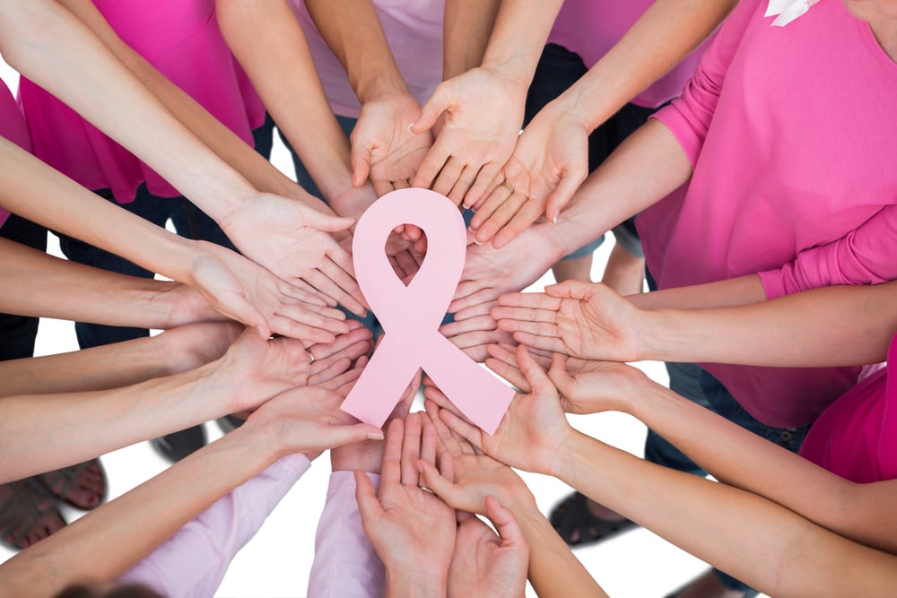 Hands joined in circle holding breast cancer struggle symbol  on white background